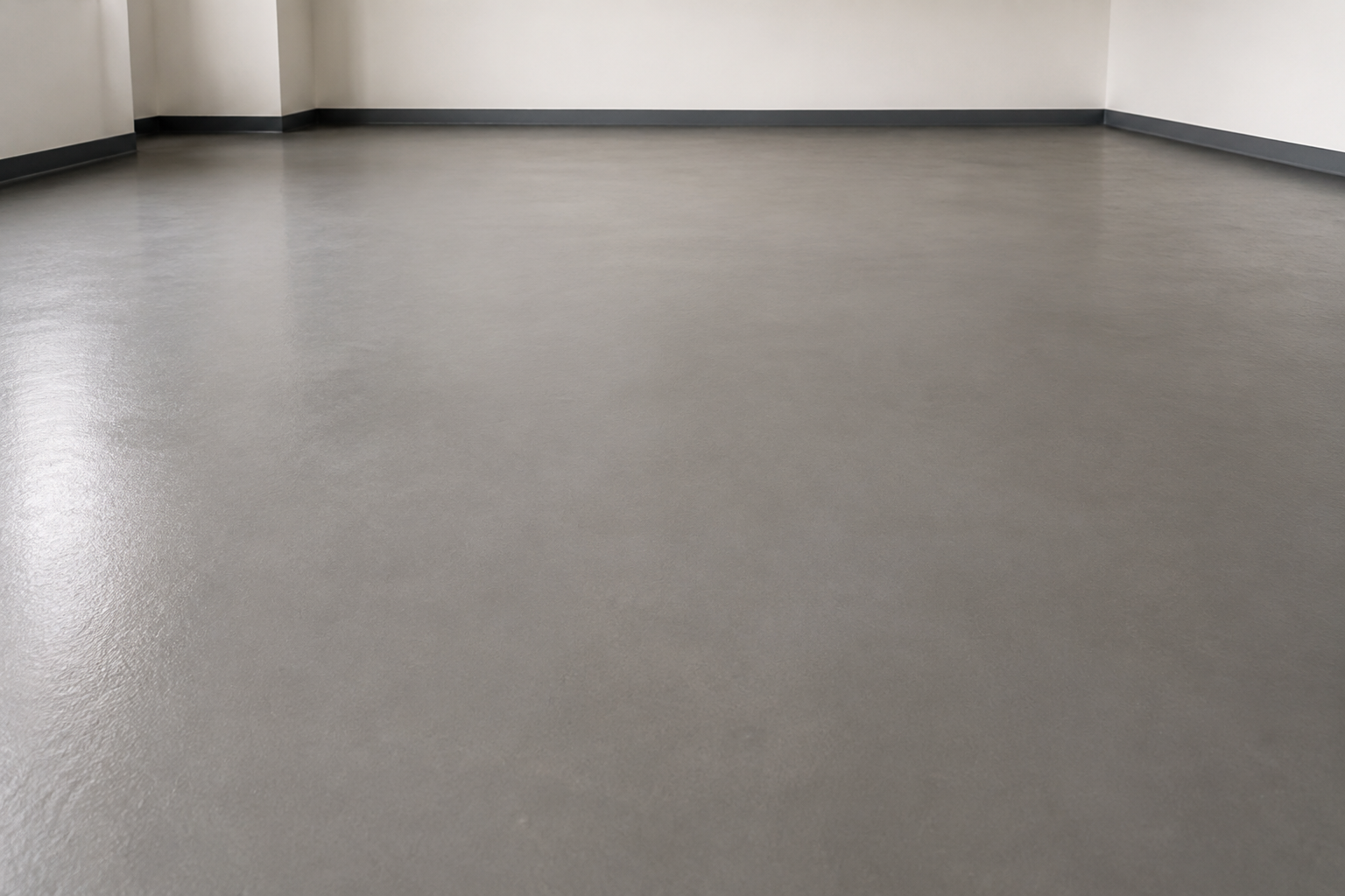 Smooth, freshly levelled grey screed subfloor prepared ahead of a commercial flooring installation